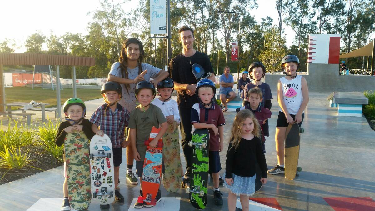 SKATE: ASCI coaches Bryan Rodriguez, left, and James Stuurman take a team of
enthusiastic young skate enthusiasts through the paces at the new Flagstone skate plaza. Photo: Supplied