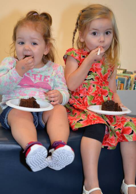 CAKE TIME: Lilley Reed and Frankie-rae Grainger join the celebrations at Logan Hyperdome Library. Photo: Supplied.