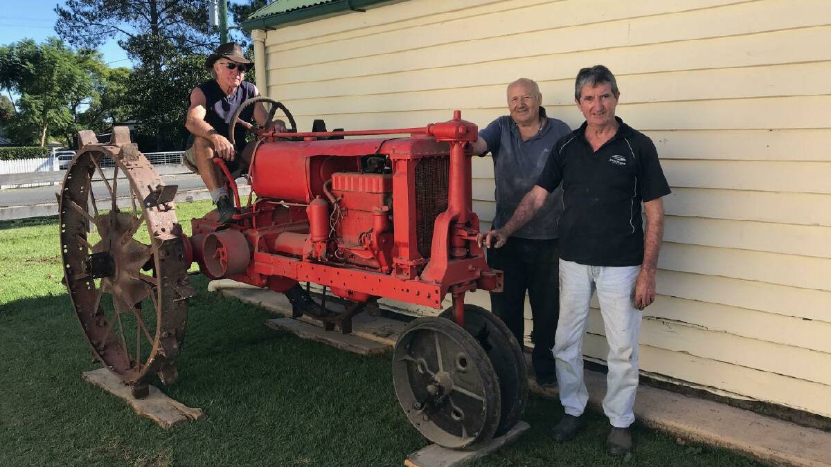 TRANSPORT: Dennis Love, Garry Evans and Arthur Tierney with an historic tractor. Photo: Supplied