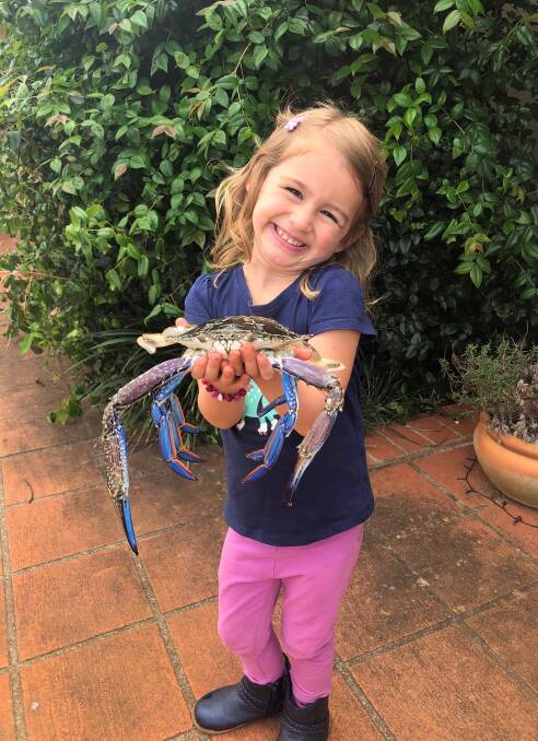 PROUD: Ellissa Price with one of the sand crabs she caught with her dad around Coochiemudlo Island.