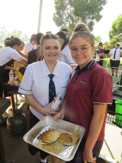 Camryn Robertson and Shari Wiltshire distribute pancakes.
