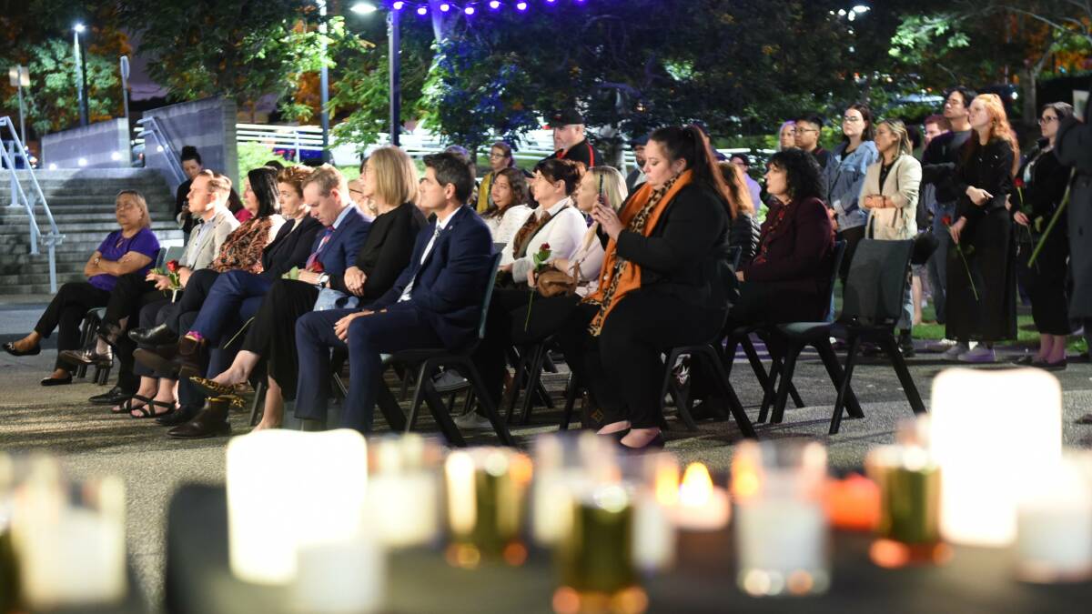 Sombre: A candlelit vigil for DV victims was at Logan Entertainment Centre in May. About 100 people were on hand to pay tribute to victims.