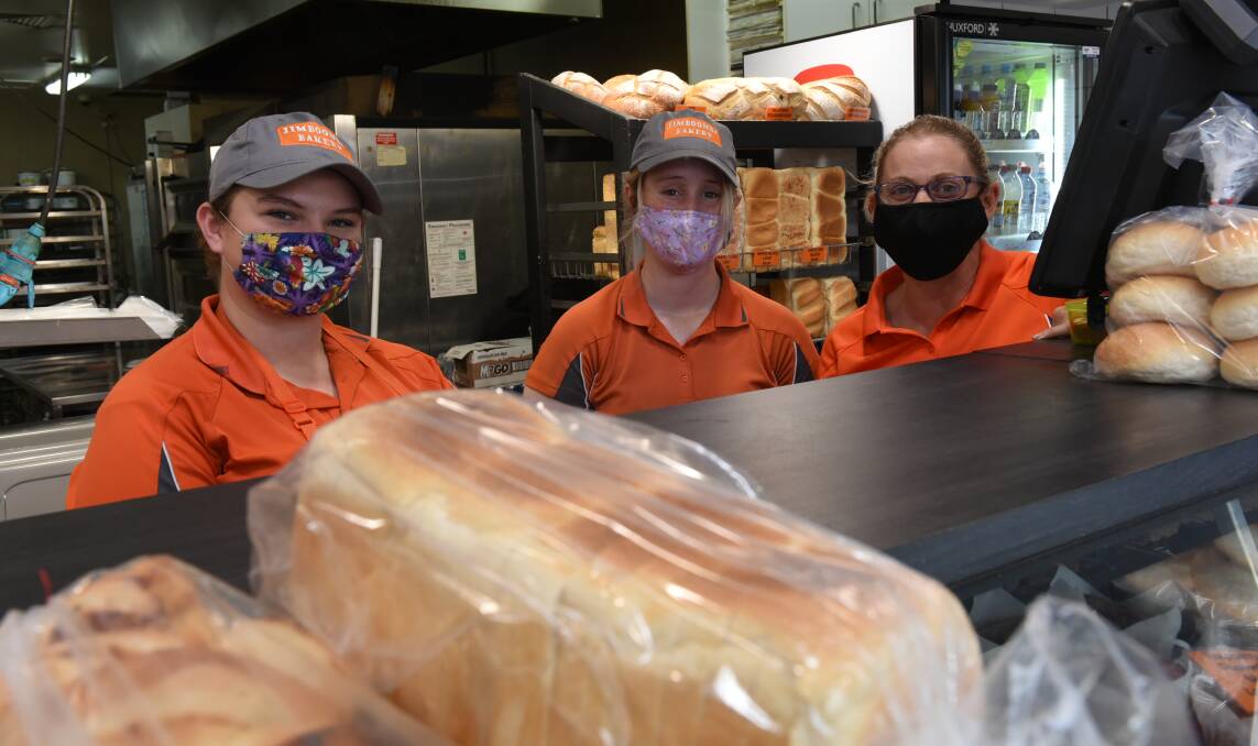 MASKED UP: Jimboomba Bakery staff Olivia Jakes and Annaleise Thomson with owner Holly Wilson on the second day of the snap three-day lockdown. Photo: Matt McLennan
