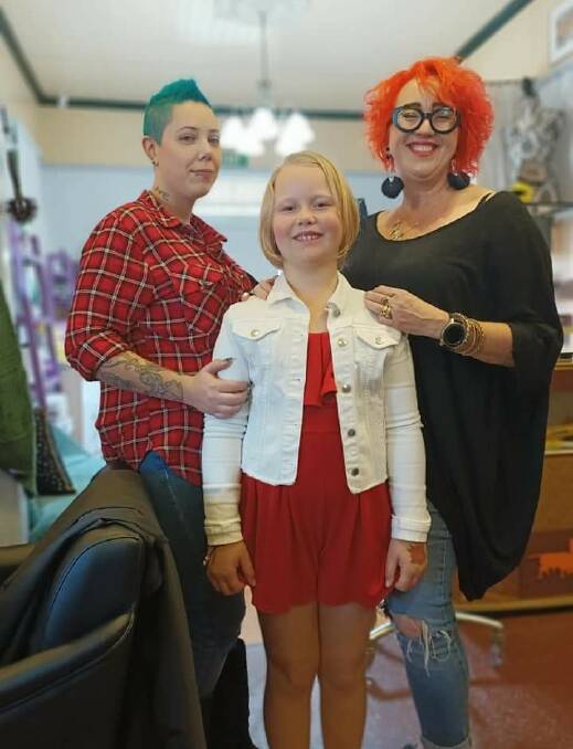 Locks gone: Caitlyn Arnold with Pernickety staff member Sophie Evans and owner Angelique Lammerts-Hartjes after her hair cut for charity.