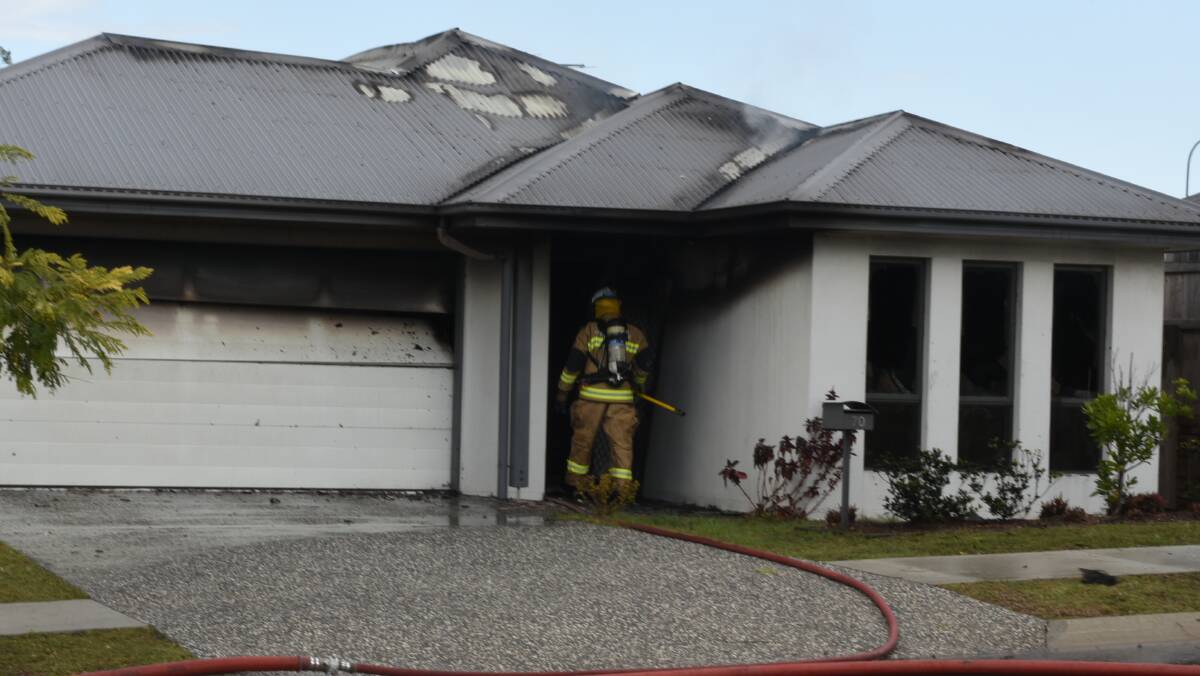FIRE: Firefighters at a house fire on Trailblazer Drive this afternoon. Photo: Matt McLennan