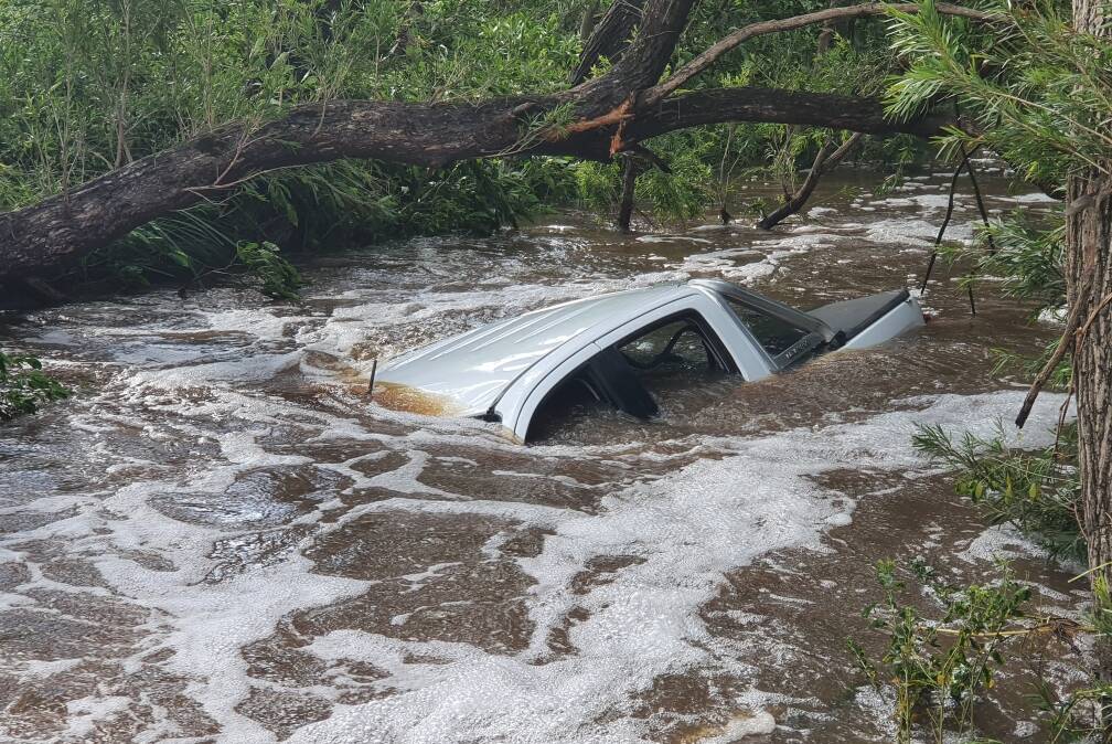 Lucky: A motorist was rescued at Biddaddaba. This is their car in the floodwater.