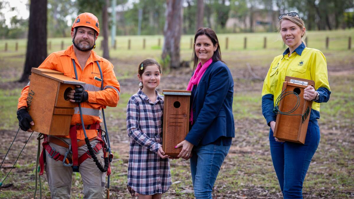 Homes for animals: Ben Gunston from Ecosure, Ruby and Natalie Willcocks and Logan Water's Morgan Dodds installing nesting boxes at Richard Wilson Park.