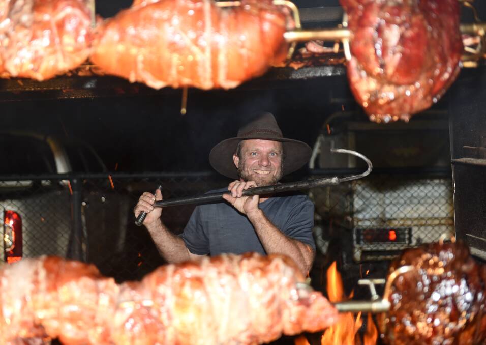 HOOKED ON HOT MEAT: Randell Lewis at the RollnSpit Wagon in Rotary Park for Jimboomba's Eats and Beats. Photo: Matt McLennan
