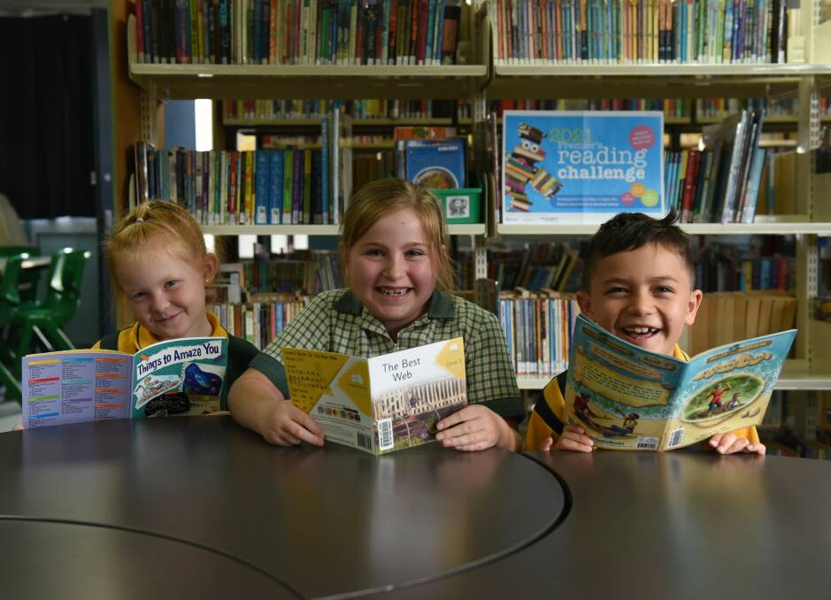 BOOKWORMS: Audrina Lee, Matilda Ellem and Dante Manukau are star readers at Jimboomba State School. They say they are loving absorbing the written word. Photo: Matt McLennan