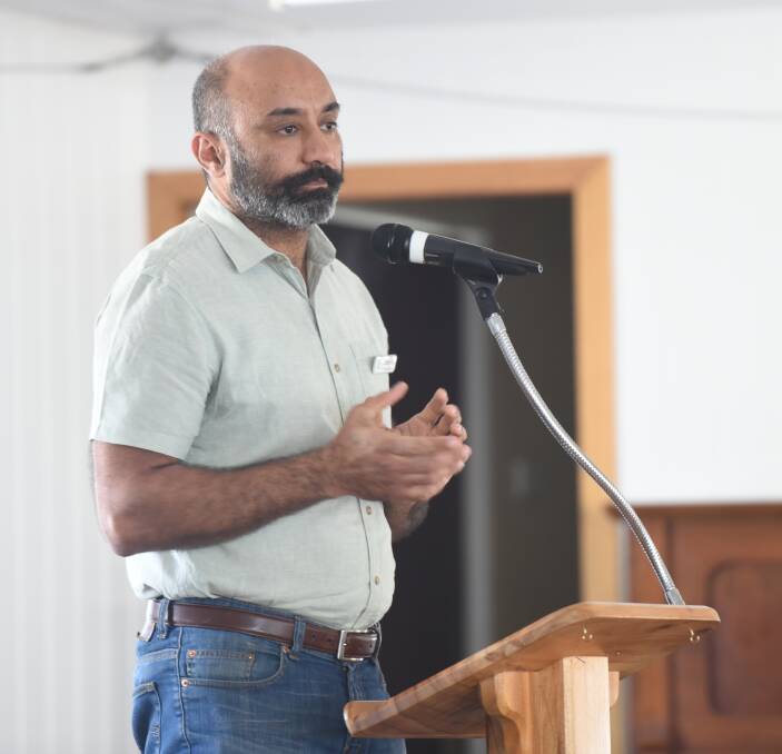 At the lectern: Navdeep Singh speaks at Saturday's election forum at Jimboomba. Photo: Matt McLennan
