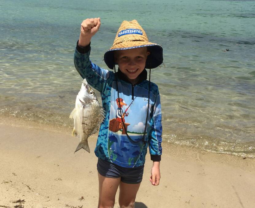 Nice bream: Six-year-old Benny Henkel with a healthy bream caught at Peel Island, which he released. 