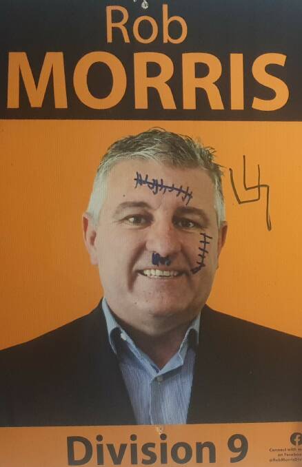 Division 9 candidate Rob Morris had swastikas and scars drawn on his election signage.