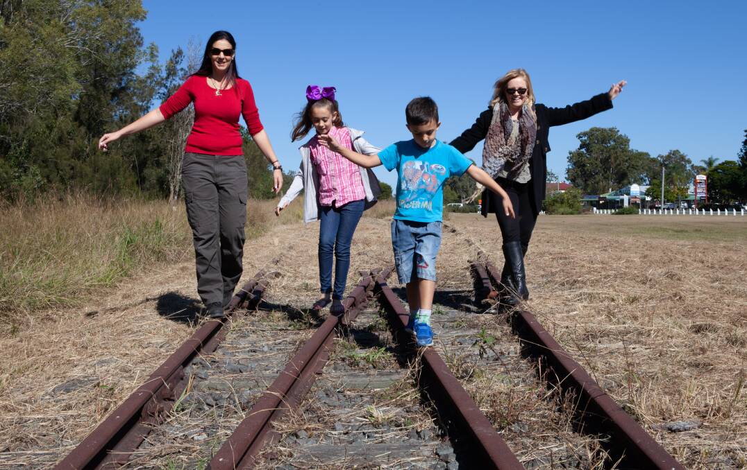 Balancing act: Christie Smith, Jasmine McDonald, Tyler McDonald and Division 4 councillor Laurie Koranski check out the proposed Logan Village to Yarrabilba Rail Trail.