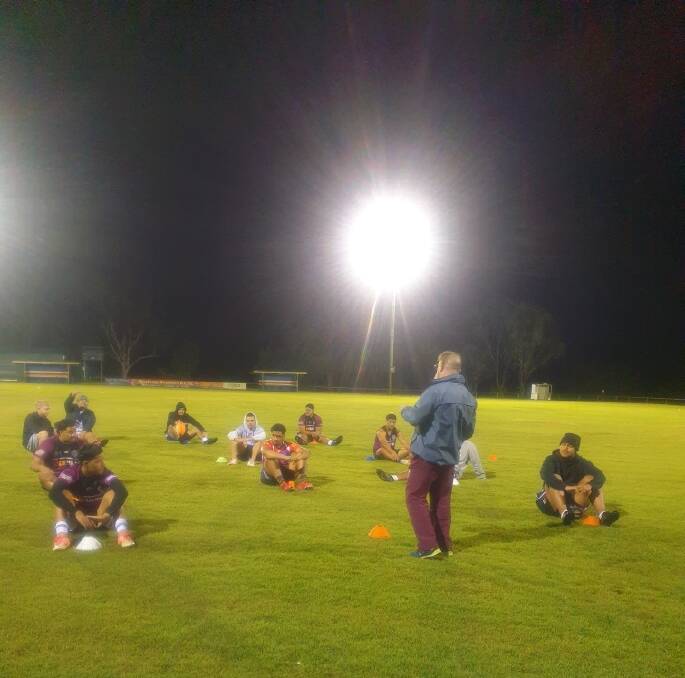 Social distancing: Geoff Burr speaks to his players at a Mustangs training session.