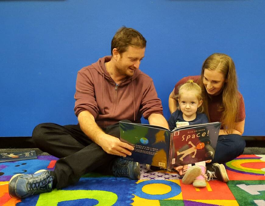 PREVIEW: Logan family Mark, Charlie and Stacey Eldred take a sneak peek at the featured book for this years Simultaneous Storytime.
