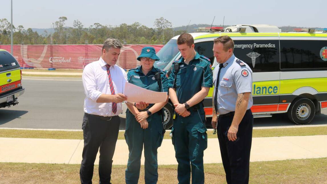 Starting soon: Linus Power with paramedics looking over plans for the Yarrabilba ambulance station. Construction will soon begin on the facility.