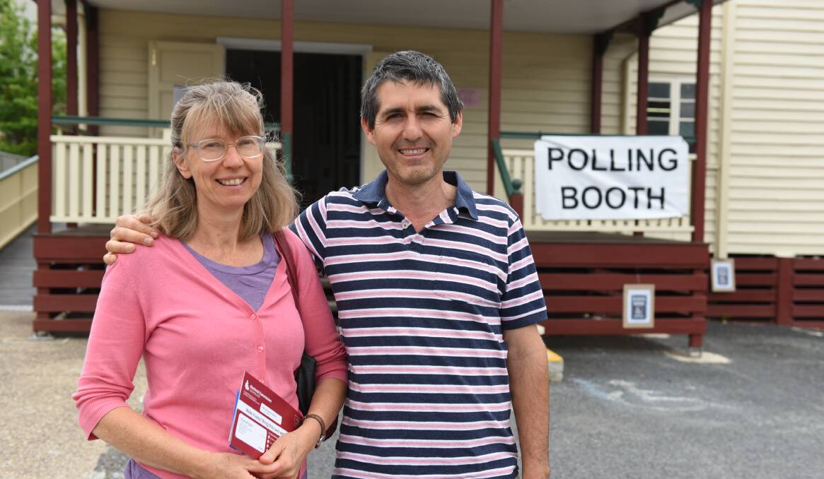 Pre-polling: Anneli and Catalin Florea were among people casting their votes early at Jimboomba this week. Polling booth volunteers reported a steady stream of voters. Photo: Matt McLennan