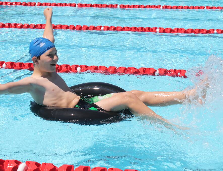 Ryan Clayton, 11, took a leisurely splash down the pool while taking part in the tyre tube race.